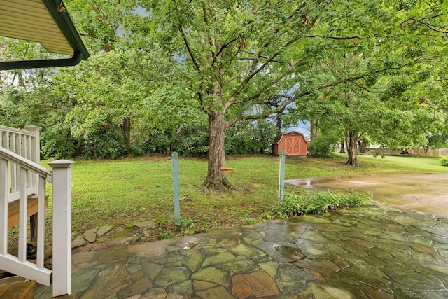 view of yard with a shed and a patio area