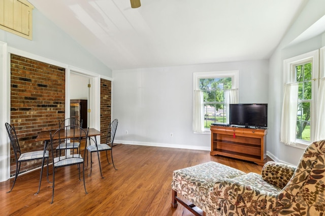 living room featuring lofted ceiling, hardwood / wood-style flooring, and a wealth of natural light