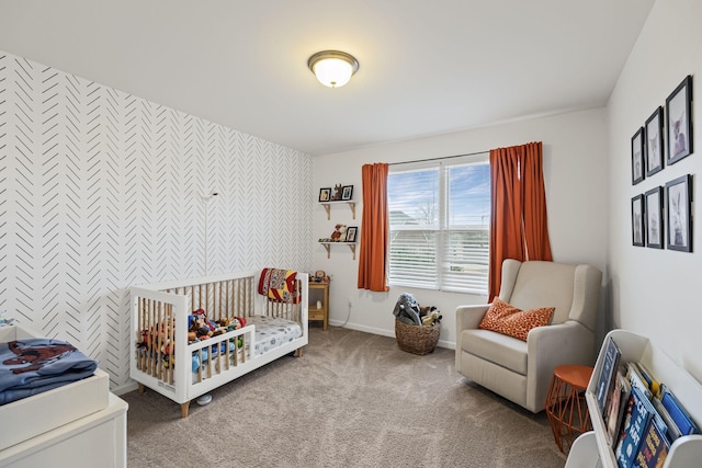 bedroom featuring a nursery area and carpet