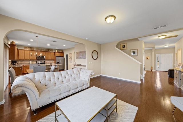 living room featuring dark hardwood / wood-style floors and a chandelier