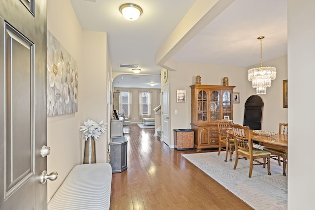 interior space featuring a notable chandelier and dark hardwood / wood-style flooring