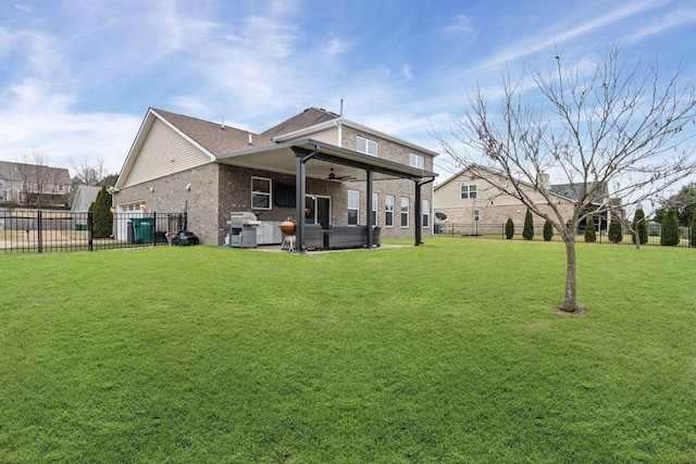 back of property featuring outdoor lounge area, a yard, and ceiling fan