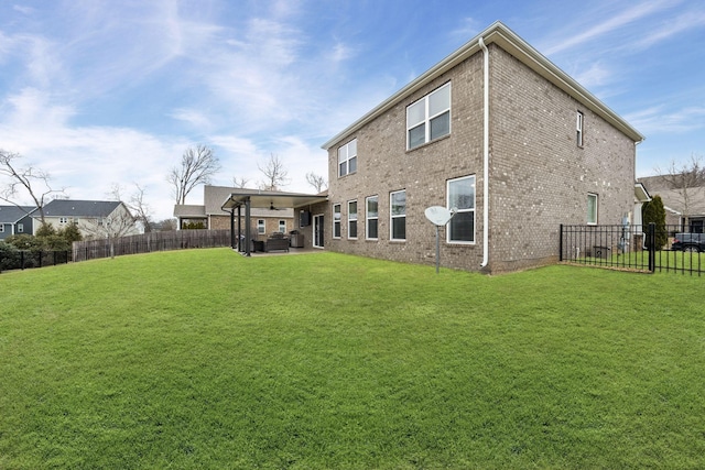 rear view of house featuring a yard