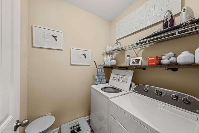 clothes washing area with washer and clothes dryer