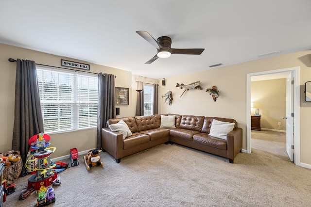 carpeted living room featuring ceiling fan