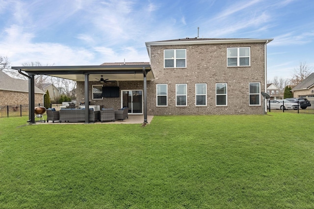 rear view of house featuring a lawn, outdoor lounge area, a patio, and ceiling fan