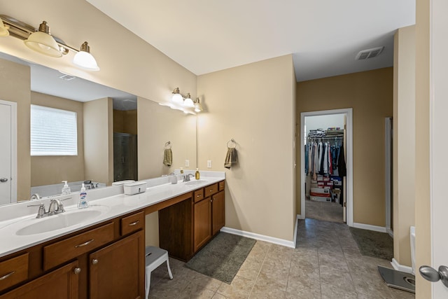 bathroom featuring vanity, plus walk in shower, and tile patterned flooring