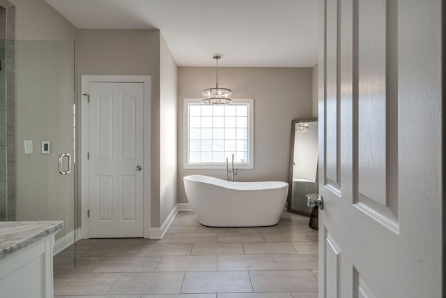 bathroom with a notable chandelier, shower with separate bathtub, and vanity