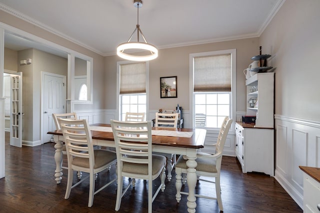 dining space with ornamental molding and dark hardwood / wood-style floors