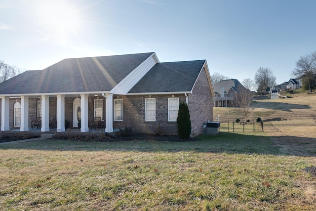 view of front facade featuring a porch, a front lawn, and central air condition unit