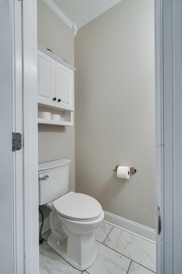 bathroom with crown molding and toilet