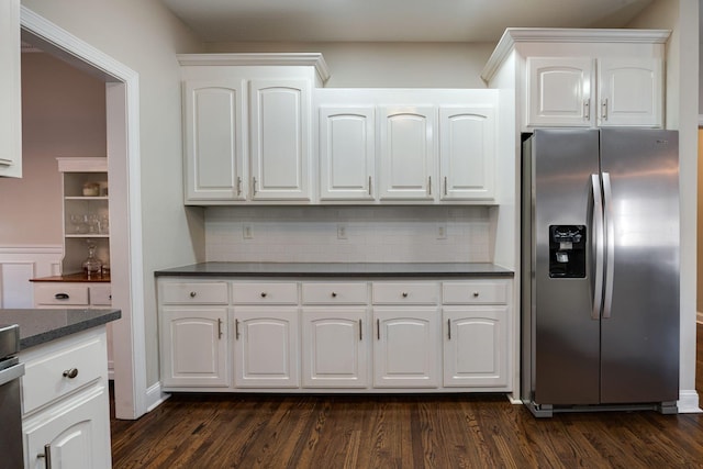 kitchen with white cabinetry, backsplash, dark wood-type flooring, and stainless steel fridge