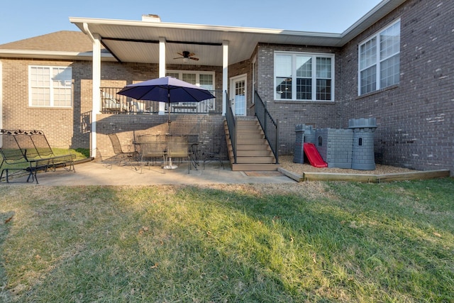 rear view of house with a lawn, a patio, and ceiling fan