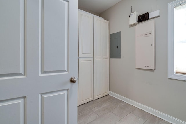 interior space with a wealth of natural light, electric panel, and light tile patterned floors