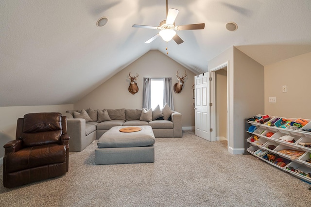 living room featuring ceiling fan, carpet flooring, and vaulted ceiling