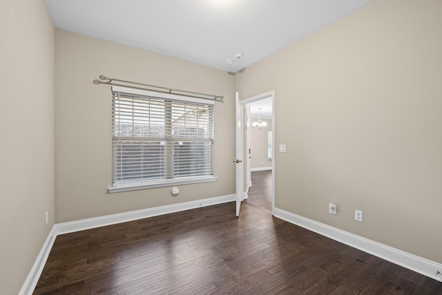 unfurnished room with dark hardwood / wood-style floors