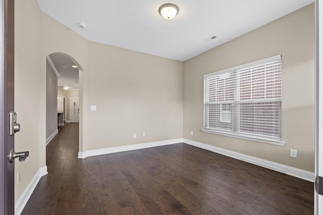 spare room featuring dark hardwood / wood-style flooring