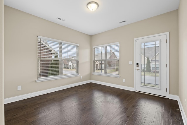 spare room featuring dark hardwood / wood-style flooring