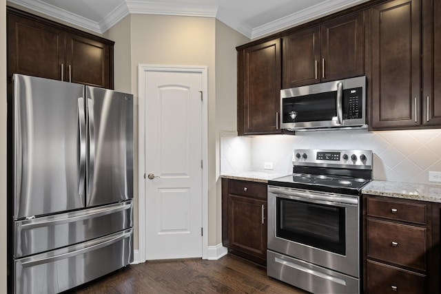 kitchen featuring dark brown cabinetry, light stone countertops, and stainless steel appliances