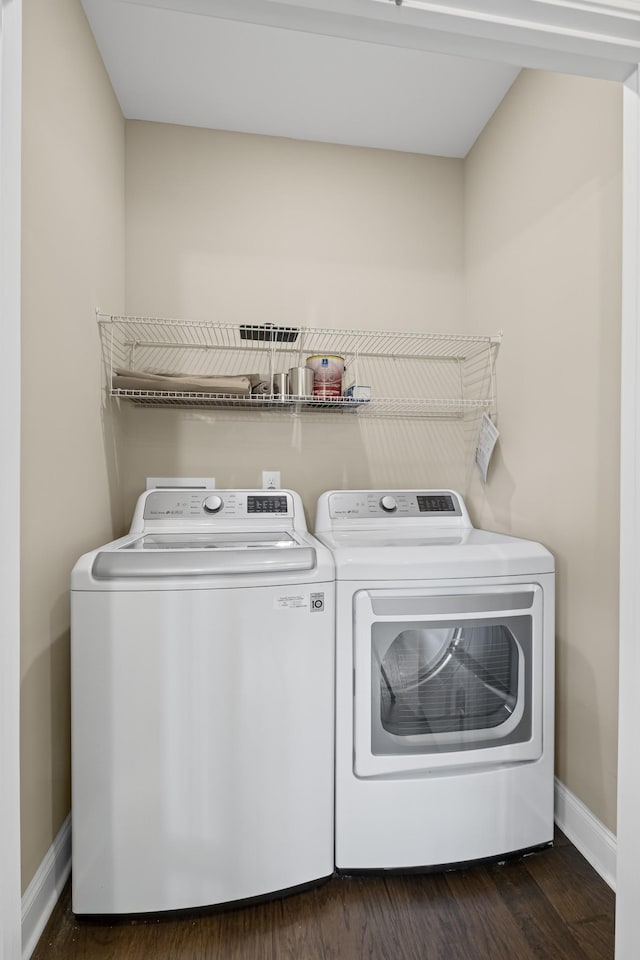 laundry room with dark hardwood / wood-style flooring and washer and clothes dryer