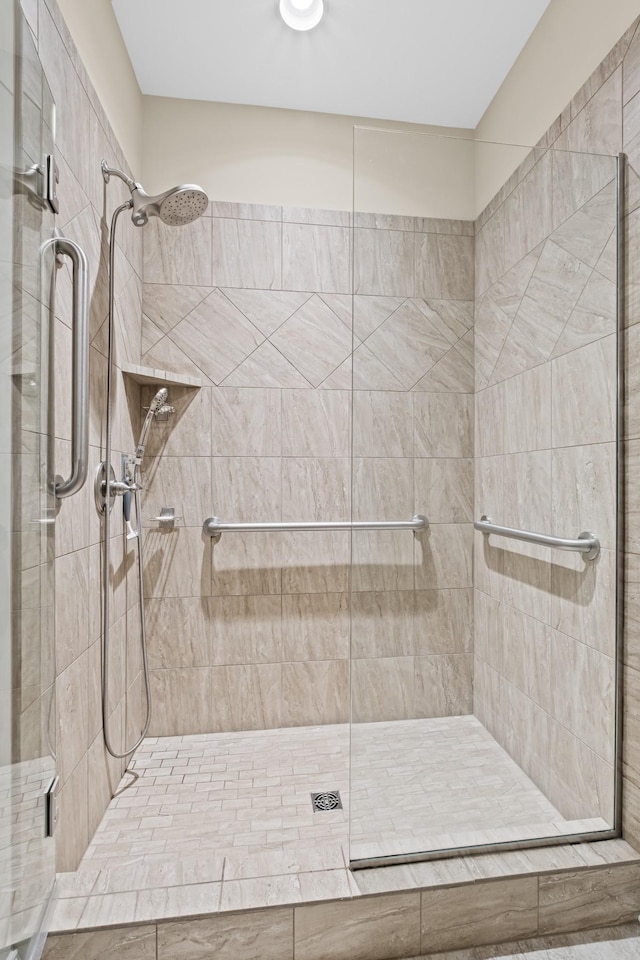 bathroom with a shower with shower door