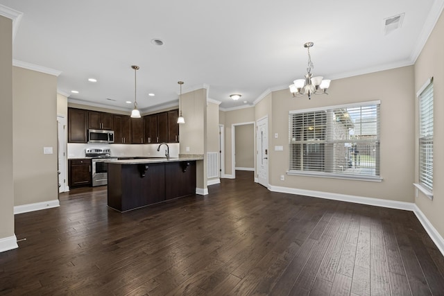 kitchen featuring hanging light fixtures, appliances with stainless steel finishes, a breakfast bar area, and dark hardwood / wood-style flooring