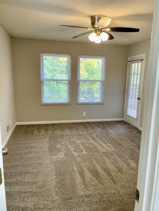 spare room with carpet and ceiling fan