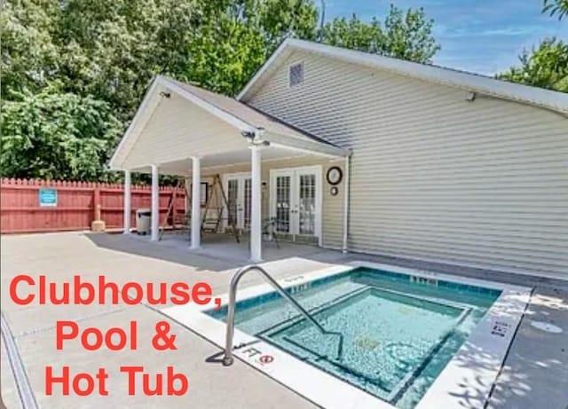 view of swimming pool with a patio and french doors