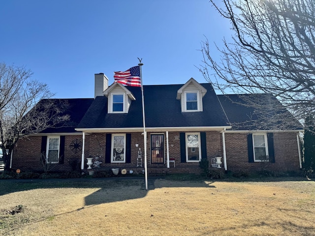 cape cod home with a front yard and a porch