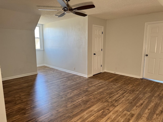 bonus room with ceiling fan, dark wood-type flooring, and a textured ceiling