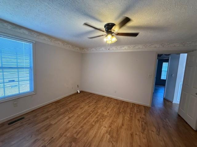 unfurnished room with hardwood / wood-style flooring, a textured ceiling, and ceiling fan