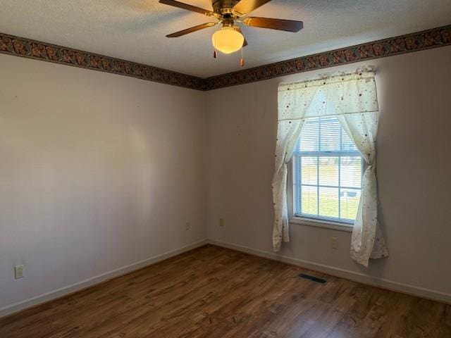 spare room with hardwood / wood-style flooring, ceiling fan, and a textured ceiling