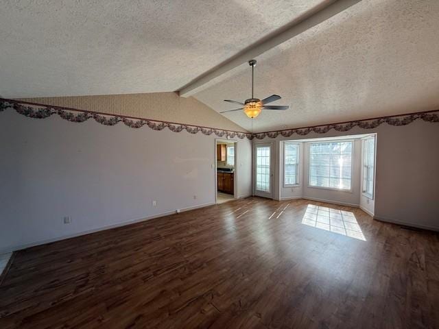 spare room with hardwood / wood-style floors, vaulted ceiling with beams, a textured ceiling, and ceiling fan