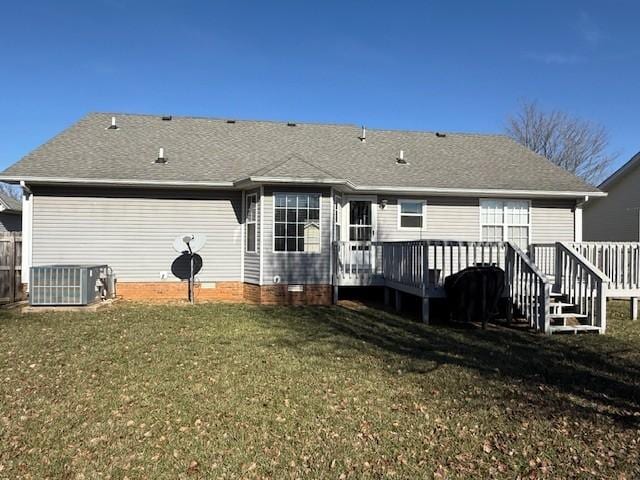 rear view of property with a yard, central air condition unit, and a deck