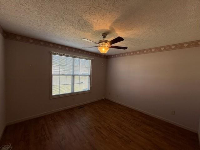 unfurnished room featuring ceiling fan, dark hardwood / wood-style floors, and a textured ceiling