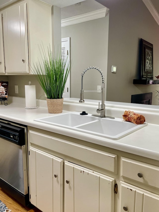 kitchen featuring ornamental molding, sink, and stainless steel dishwasher