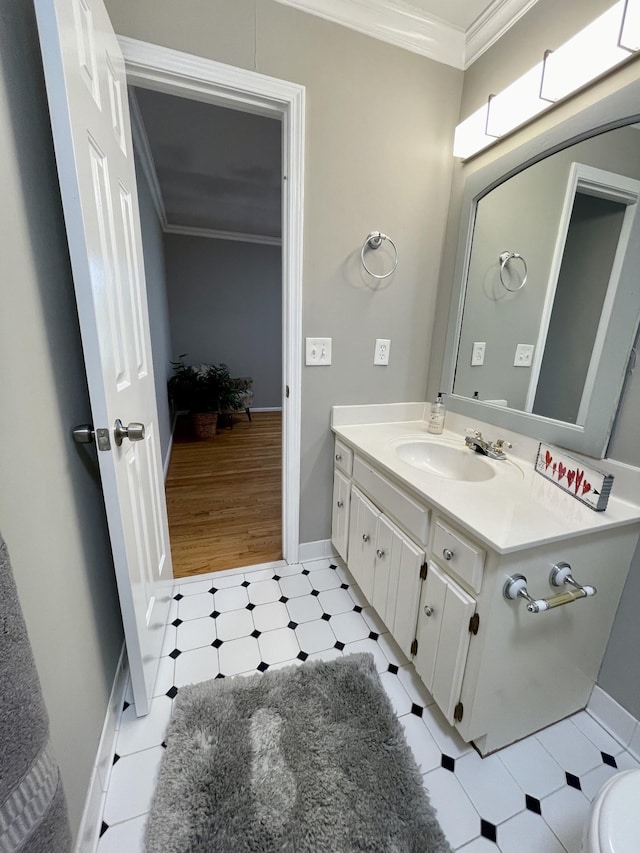 bathroom with ornamental molding and vanity