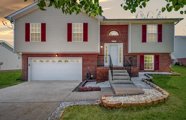 split foyer home with a garage and a lawn