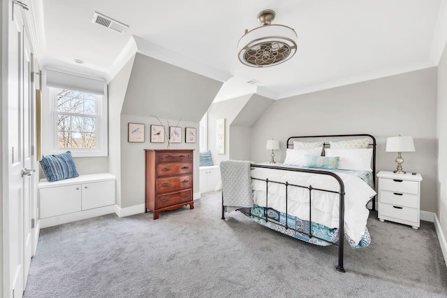 bedroom featuring crown molding, vaulted ceiling, and light colored carpet