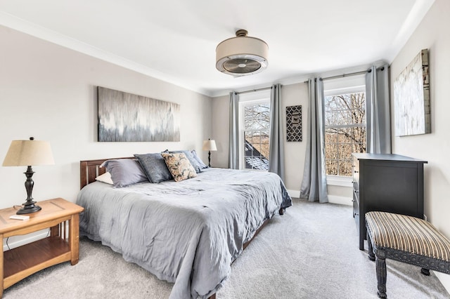 bedroom with ornamental molding and light carpet