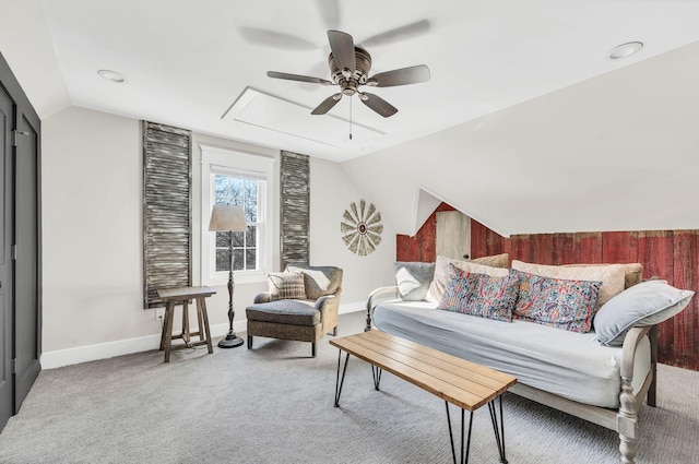 carpeted living room featuring ceiling fan and lofted ceiling