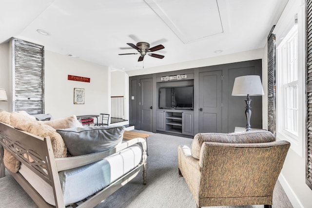 living room featuring ceiling fan and carpet