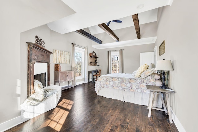 bedroom with vaulted ceiling with beams and dark hardwood / wood-style floors