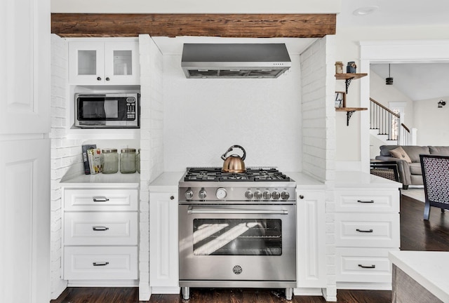 kitchen featuring white cabinetry, stainless steel appliances, beam ceiling, decorative backsplash, and wall chimney range hood