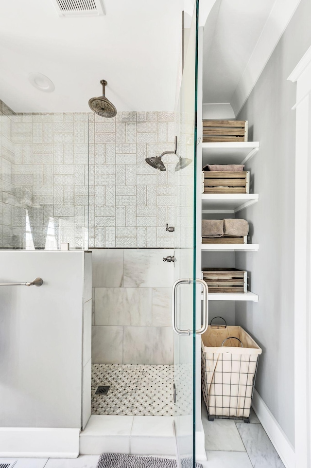 bathroom with a shower with door and ornamental molding