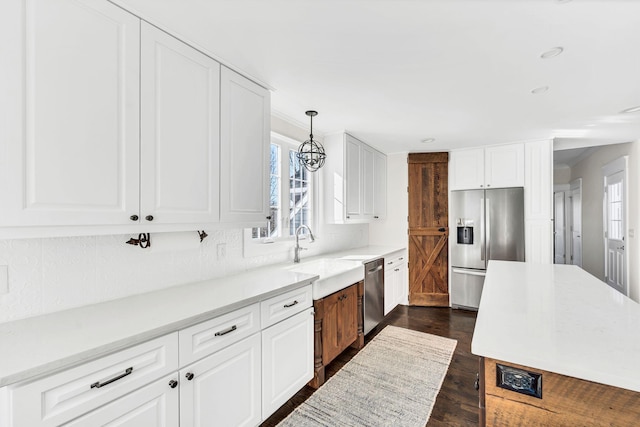 kitchen featuring appliances with stainless steel finishes, sink, and white cabinets