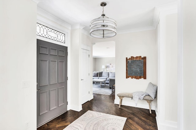 foyer entrance with ornamental molding and dark hardwood / wood-style flooring