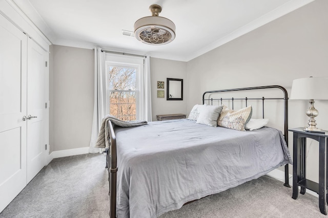 carpeted bedroom featuring ceiling fan and ornamental molding