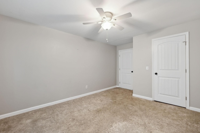 unfurnished room featuring light colored carpet and ceiling fan