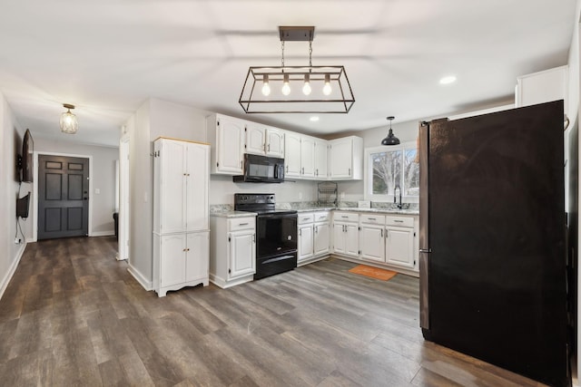 kitchen with dark hardwood / wood-style floors, decorative light fixtures, sink, white cabinets, and black appliances